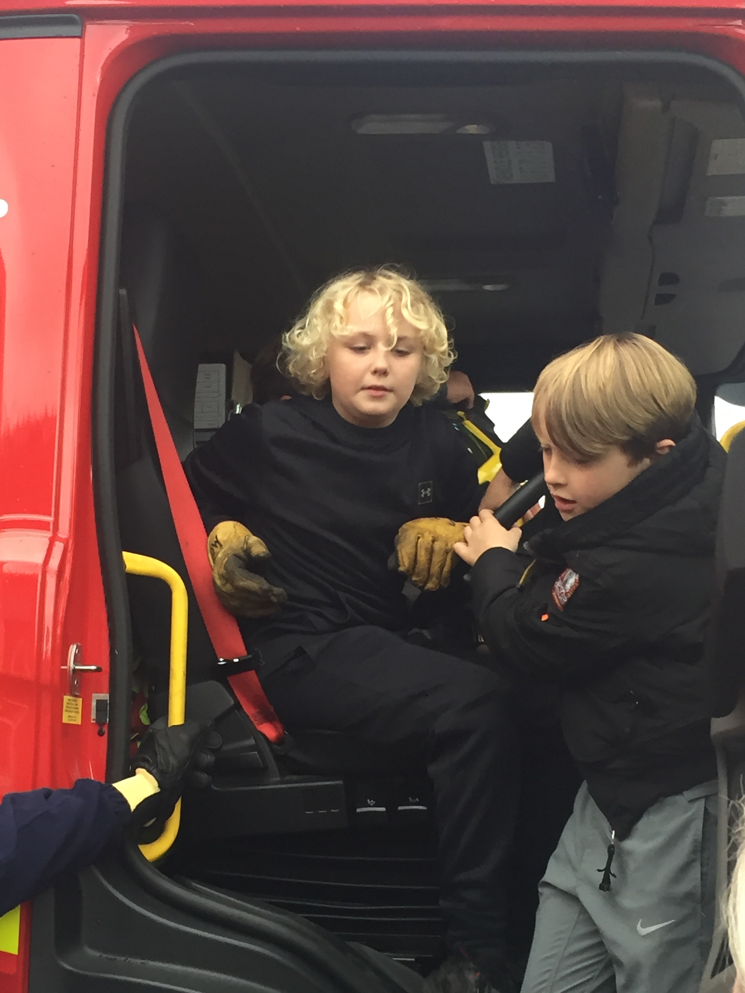 two children sitting in a fire engine