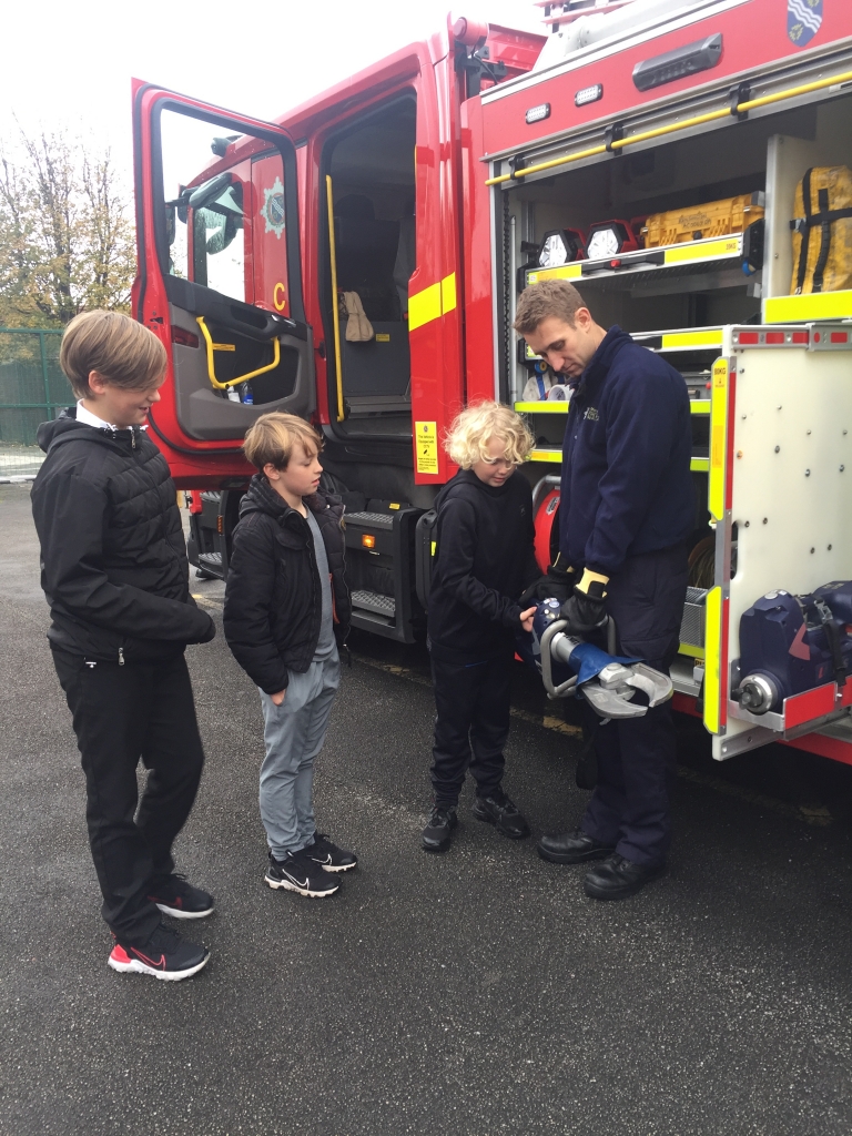 children talking to a fireman