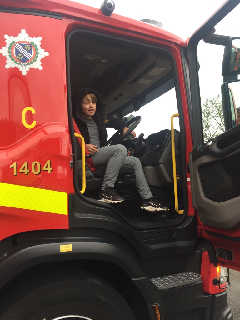 child sitting in a fire engine