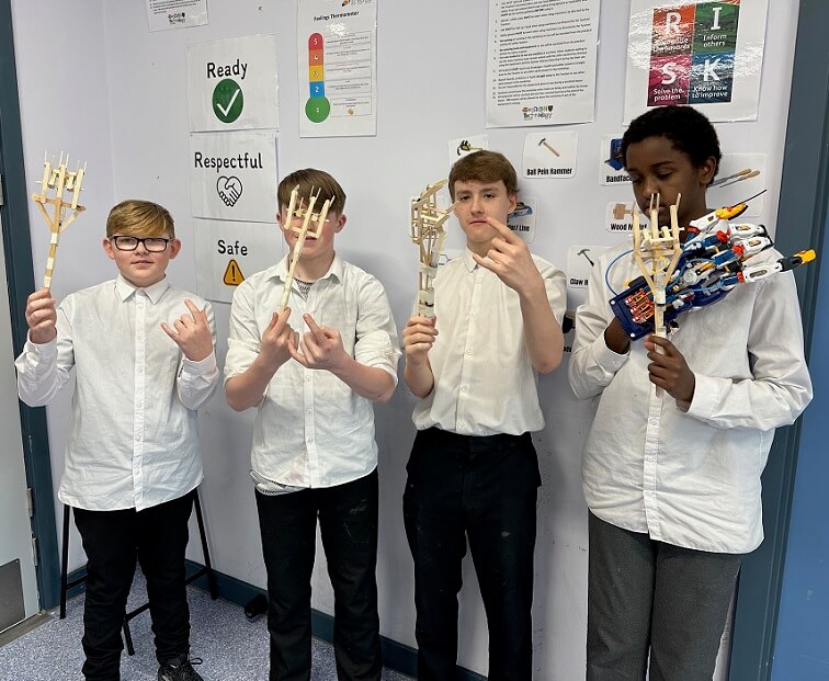 Students show their hydraulic arm project