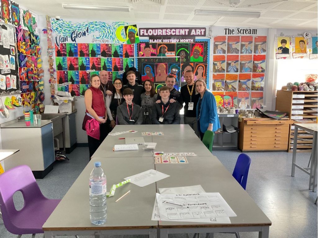Past students in the art room with teachers